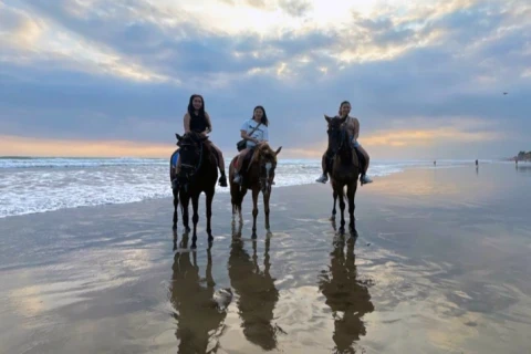 fun group riding along the beach beach